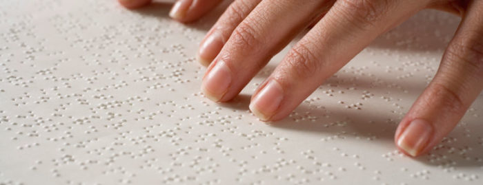 Woman reading braille
