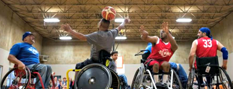 Men in wheelchairs playing basketball